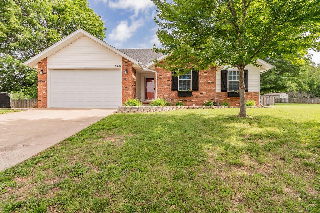 5206 N Annodale Ct, Ozark, MO 65721 - ranch-style house featuring brick siding, an attached garage, and concrete driveway