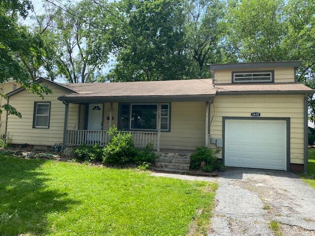 1835 S Franklin Ave, Springfield, MO 65807 - view of front of home featuring covered porch, a front yard, and driveway