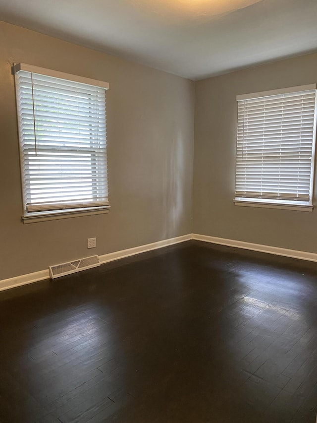 1835 S Franklin Ave, Springfield, MO 65807 - spare room with baseboards and dark wood-type flooring