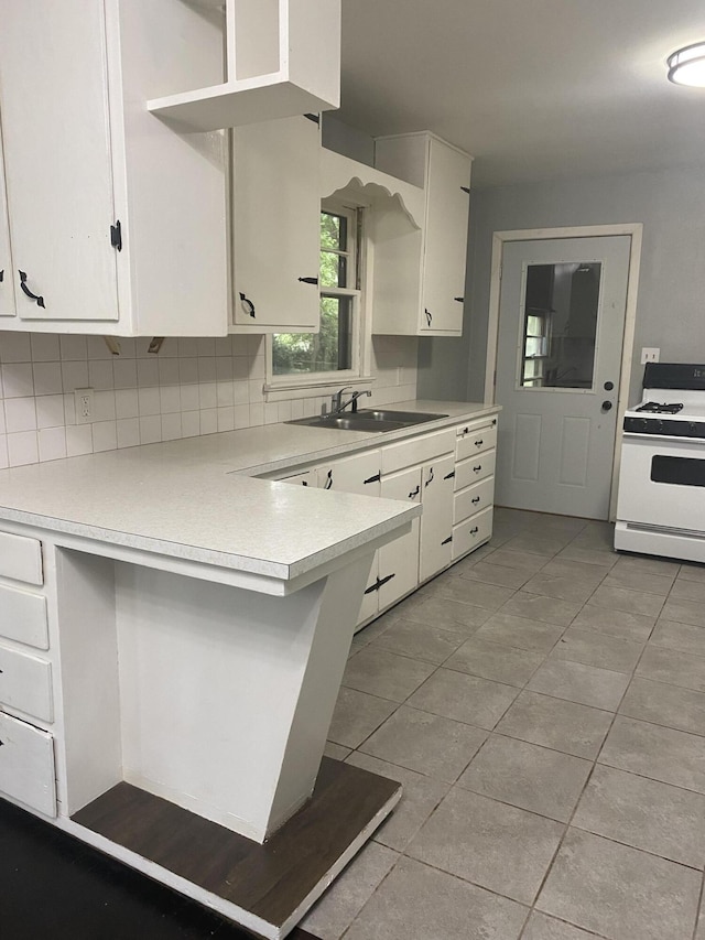 1835 S Franklin Ave, Springfield, MO 65807 - kitchen featuring gas range gas stove, light countertops, white cabinets, and a peninsula