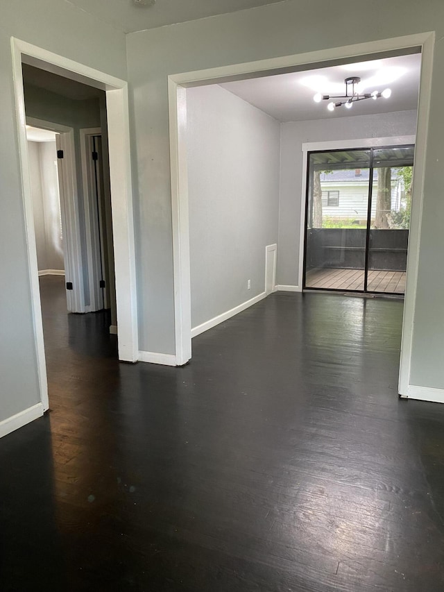 1835 S Franklin Ave, Springfield, MO 65807 - unfurnished room featuring dark wood-type flooring and a chandelier