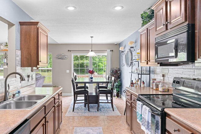 19662 Ladera Rd, Waynesville, MO 65583 - kitchen featuring stainless steel appliances, a sink, backsplash, light countertops, and recessed lighting