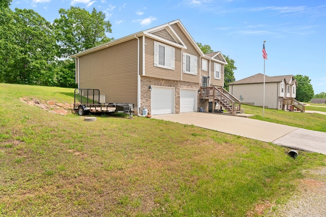 19662 Ladera Rd, Waynesville, MO 65583 - view of side of home with a garage, concrete driveway, stairs, and a lawn
