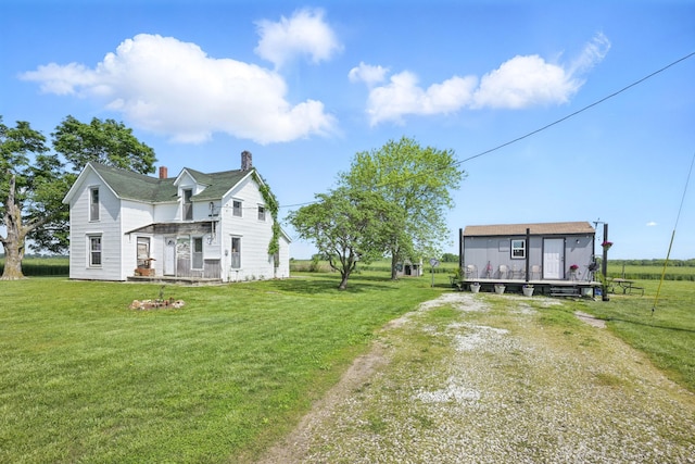 8209 Locust Rd, Carthage, MO 64836 - view of home's exterior featuring a yard and a chimney