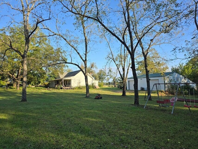 3590 County Road 7140, West Plains, MO 65775 - view of grassy yard with a detached garage and a playground
