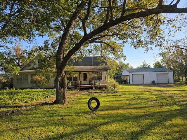 3590 County Road 7140, West Plains, MO 65775 - rear view of house featuring a lawn, covered porch, a garage, an outdoor structure, and driveway