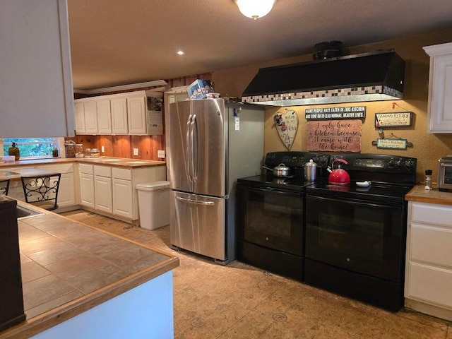 3590 County Road 7140, West Plains, MO 65775 - kitchen with black electric range oven, tile countertops, freestanding refrigerator, and white cabinetry