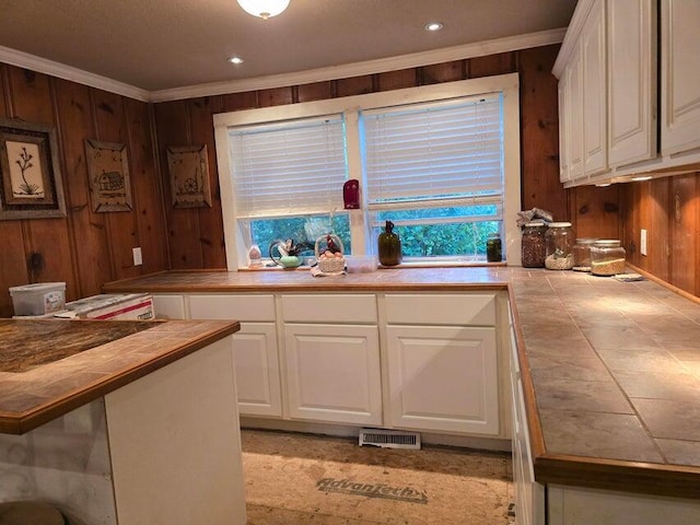 3590 County Road 7140, West Plains, MO 65775 - kitchen with tile countertops, crown molding, white cabinets, wooden walls, and recessed lighting