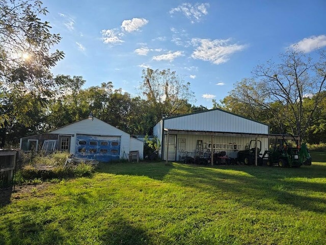 3590 County Road 7140, West Plains, MO 65775 - view of green lawn featuring a detached garage, an outbuilding, and an outdoor structure