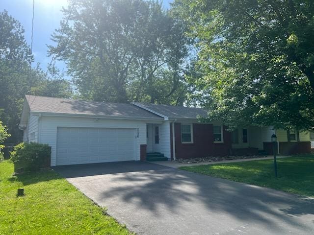2124 S Kimbrough Ave, Springfield, MO 65807 - ranch-style home featuring asphalt driveway, a front lawn, and a garage
