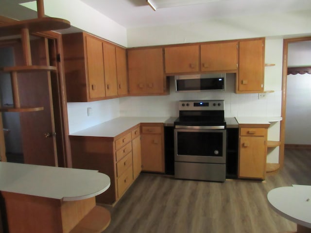 2124 S Kimbrough Ave, Springfield, MO 65807 - kitchen featuring stainless steel appliances, wood finished floors, light countertops, tasteful backsplash, and open shelves