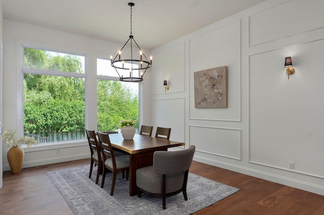 1698 N Marlowe Ave, Springfield, MO 65802 - dining room featuring a decorative wall, a chandelier, and dark wood-style flooring