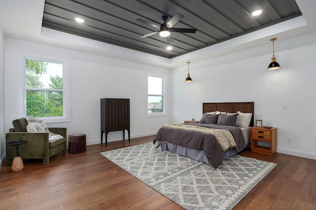 1698 N Marlowe Ave, Springfield, MO 65802 - bedroom featuring a raised ceiling, multiple windows, baseboards, and dark wood-type flooring