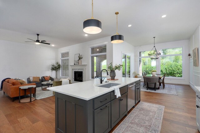 1698 N Marlowe Ave, Springfield, MO 65802 - kitchen featuring a sink, light countertops, a premium fireplace, wood finished floors, and recessed lighting
