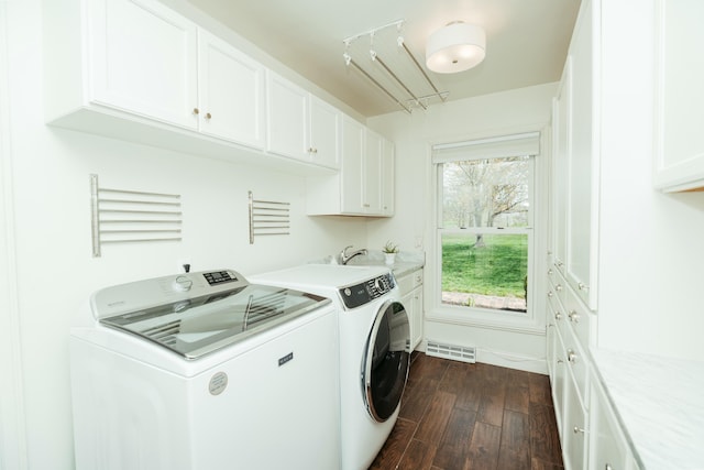 5724 E Mill St, Springfield, MO 65802 - clothes washing area with cabinet space, dark wood finished floors, and separate washer and dryer