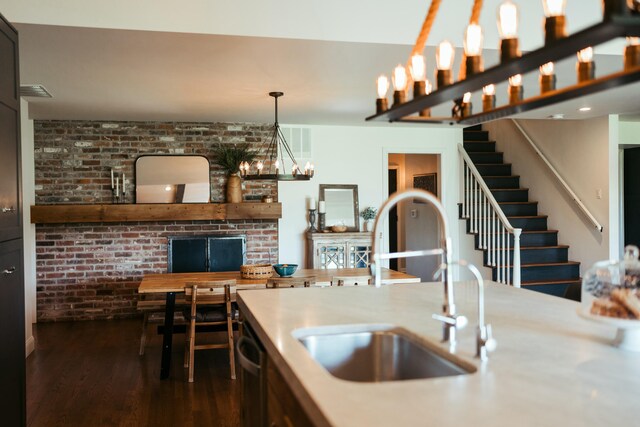 5724 E Mill St, Springfield, MO 65802 - kitchen featuring a sink, dark wood-style flooring, stainless steel dishwasher, light countertops, and pendant lighting