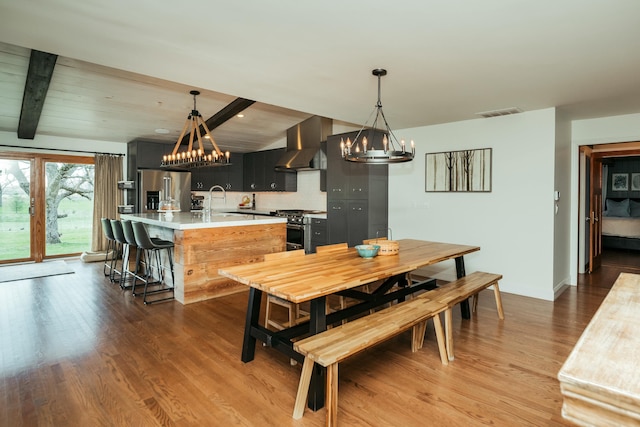 5724 E Mill St, Springfield, MO 65802 - dining area with a chandelier, wood finished floors, baseboards, and beam ceiling