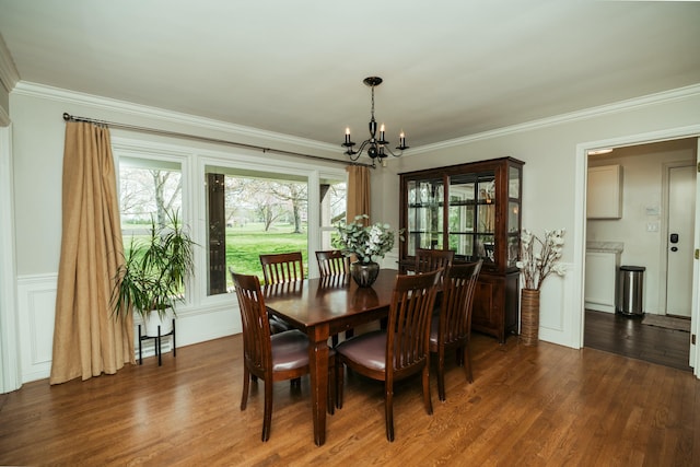 5724 E Mill St, Springfield, MO 65802 - dining room featuring a chandelier, healthy amount of natural light, ornamental molding, and wood finished floors