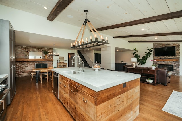 5724 E Mill St, Springfield, MO 65802 - kitchen with a sink, a fireplace, open floor plan, wood finished floors, and beam ceiling