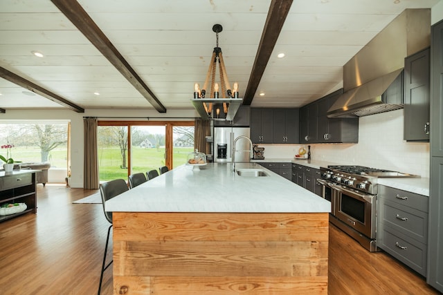 5724 E Mill St, Springfield, MO 65802 - kitchen featuring stainless steel appliances, a sink, beamed ceiling, healthy amount of natural light, and light countertops