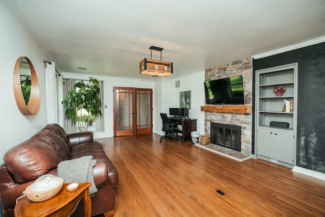 5724 E Mill St, Springfield, MO 65802 - living area featuring wood finished floors, a fireplace, and ornamental molding