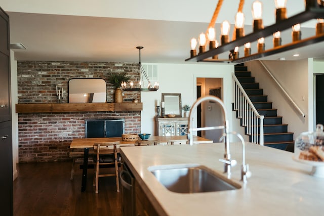 5724 E Mill St, Springfield, MO 65802 - kitchen featuring a sink, dark wood-style flooring, stainless steel dishwasher, light countertops, and pendant lighting