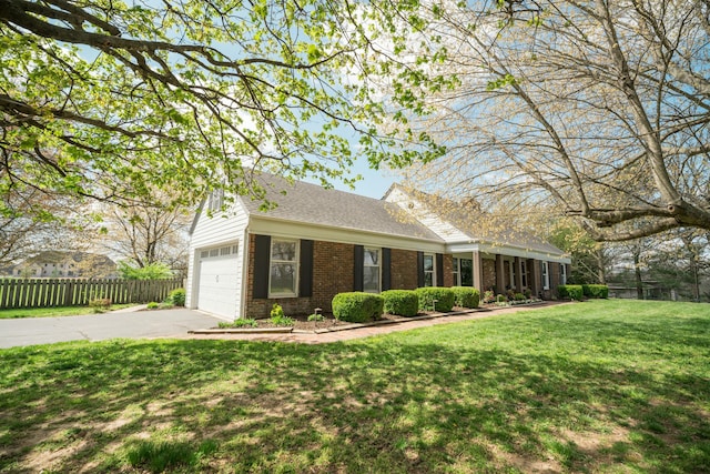 5724 E Mill St, Springfield, MO 65802 - ranch-style home with brick siding, asphalt driveway, a shingled roof, and a garage