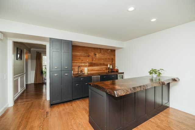 5724 E Mill St, Springfield, MO 65802 - kitchen featuring dark countertops, a peninsula, light wood-style flooring, recessed lighting, and wainscoting