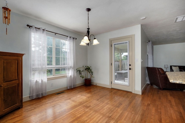 1428 S Appomattox Ave, Republic, MO 65738 - unfurnished dining area with a chandelier, light wood-style floors, and baseboards