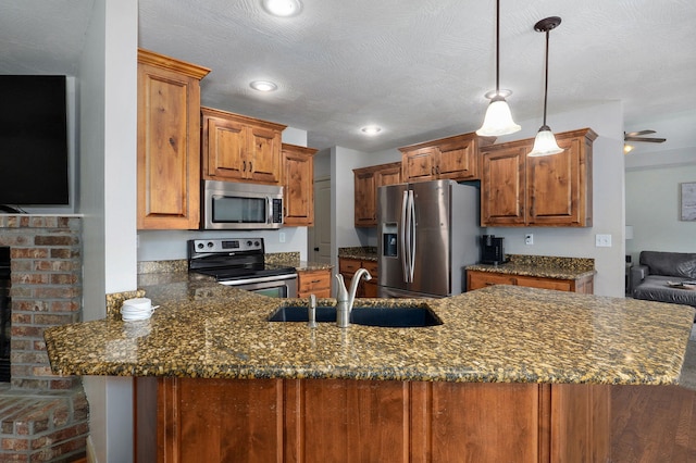 1428 S Appomattox Ave, Republic, MO 65738 - kitchen with stainless steel appliances, a sink, a peninsula, brown cabinets, and recessed lighting