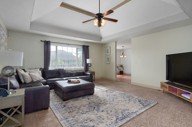 1428 S Appomattox Ave, Republic, MO 65738 - carpeted living room featuring a tray ceiling, a ceiling fan, a chandelier, and baseboards