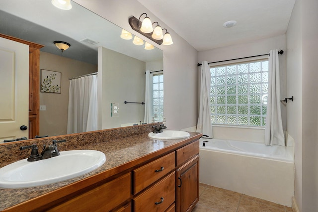 1428 S Appomattox Ave, Republic, MO 65738 - bathroom featuring a garden tub, double vanity, and tile patterned floors