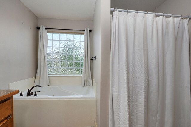 1428 S Appomattox Ave, Republic, MO 65738 - bathroom featuring a garden tub, vanity, and curtained shower