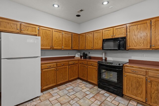 16326 Lawrence Unit 1232, Marionville, MO 65705 - kitchen with black appliances, brown cabinetry, stone finish floors, a textured ceiling, and recessed lighting