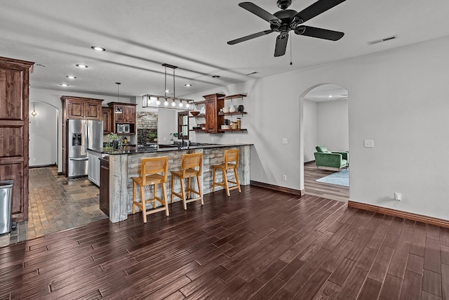 16326 Lawrence Unit 1232, Marionville, MO 65705 - kitchen featuring appliances with stainless steel finishes, arched walkways, a kitchen bar, open shelves, and ceiling fan