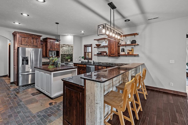 16326 Lawrence Unit 1232, Marionville, MO 65705 - kitchen featuring appliances with stainless steel finishes, open shelves, a center island, a peninsula, and dark stone countertops