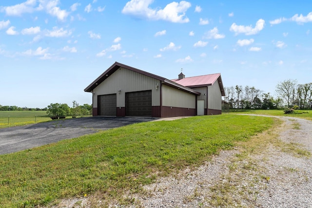 16326 Lawrence Unit 1232, Marionville, MO 65705 - view of property exterior featuring a lawn, an outbuilding, a garage, and metal roof