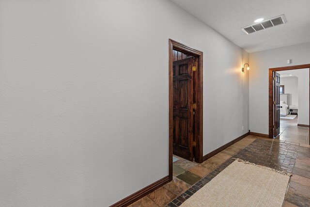 16326 Lawrence Unit 1232, Marionville, MO 65705 - corridor featuring baseboards, stone tile flooring, recessed lighting, and arched walkways