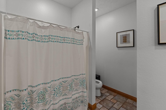 16326 Lawrence Unit 1232, Marionville, MO 65705 - bathroom featuring stone tile floors, toilet, baseboards, a shower with shower curtain, and recessed lighting