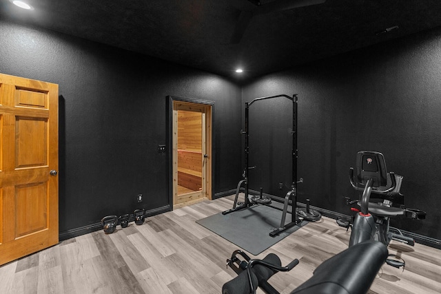 16326 Lawrence Unit 1232, Marionville, MO 65705 - workout room featuring wood finished floors, a textured wall, and baseboards