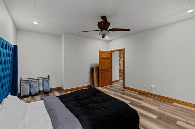 16326 Lawrence Unit 1232, Marionville, MO 65705 - bedroom featuring light wood finished floors, baseboards, a textured ceiling, a ceiling fan, and recessed lighting