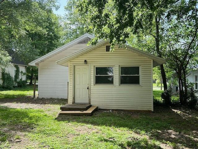 2238 N Rogers Ave, Springfield, MO 65803 - rear view of property with a lawn