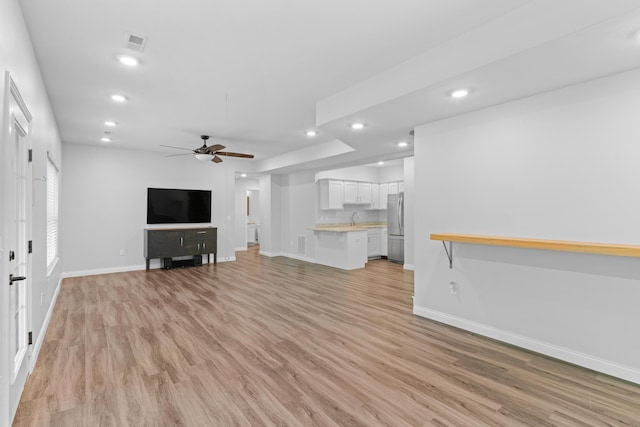 5404 S Clifton Ave, Springfield, MO 65810 - unfurnished living room featuring baseboards, light wood-style flooring, recessed lighting, and ceiling fan