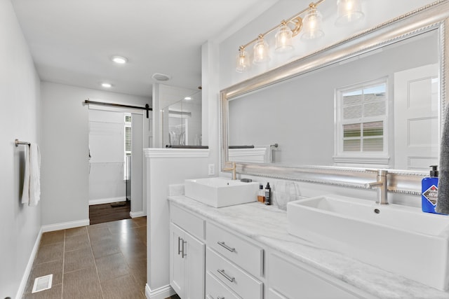 5404 S Clifton Ave, Springfield, MO 65810 - bathroom featuring baseboards, double vanity, a shower with door, and recessed lighting