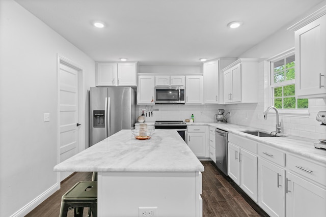 5404 S Clifton Ave, Springfield, MO 65810 - kitchen with appliances with stainless steel finishes, a sink, dark wood finished floors, white cabinetry, and tasteful backsplash