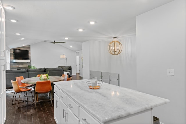 5404 S Clifton Ave, Springfield, MO 65810 - kitchen with dark wood-style flooring, white cabinets, vaulted ceiling, a center island, and light stone counters