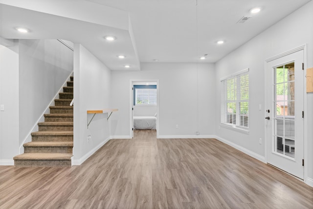 5404 S Clifton Ave, Springfield, MO 65810 - unfurnished living room featuring wood finished floors, stairway, baseboards, and recessed lighting