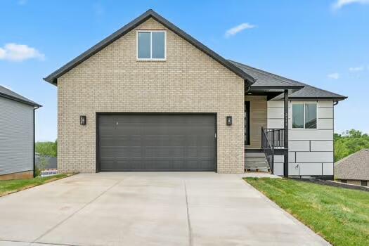2115 N 26th St, Ozark, MO 65721 - view of front of home with brick siding and driveway