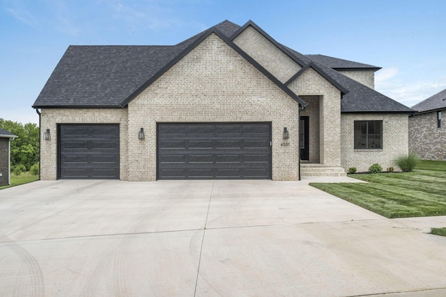 4531 E Hidden Oak St, Springfield, MO 65802 - french provincial home with a garage, brick siding, concrete driveway, roof with shingles, and a front yard