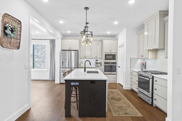 4531 E Hidden Oak St, Springfield, MO 65802 - kitchen featuring appliances with stainless steel finishes, a sink, decorative backsplash, light countertops, and recessed lighting